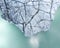 High angle shot of the tip of a glacier rock over a clear lake water