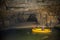 High angle shot of tourists in a yellow boat with their tour guide in the Krizna cave, Slovenia