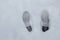 High angle shot of the traces of human feet on the snow