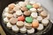 High angle shot of a tray of different types of macaroons