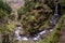 High angle shot of a waterfall and the moss covered jungle captured in Madeira Island, Portugal