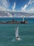 High angle shot of a white sailboat sailing out of Portland harbour in UK