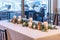 High angle shot of a white table with elegant candles and green leaves