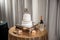 High angle shot of a white wedding cake and a basket with a champagne bottle on the table