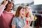 High-angle shot of young stylish female friends wearing trendy sunglasses and clothes having fun in shopping center