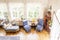 High angle of a silver lounge, blue chairs and wooden clock stan