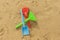 High angle summer beach colorful toys in the sand