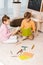 high angle view of adorable focused kids sitting on carpet and