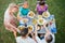 High angle view of adult friends sitting together at table, putting food on plates while having holiday dinner at