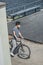 high angle view of asian teen in protective mask standing with bicycle air