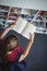 High angle view of attentive schoolgirl reading book in library