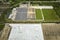 High angle view of big commercial shipping center with many freight trucks unloading and uploading goods for further