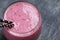 High angle view on a blackberry smoothie with banana and yogurt in a glass
