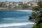 High-angle view of Bondi Beach surfers sitting out the back of the surf waiting for a wave to catch