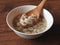 High angle view of a bowl of peanut soup isolated on wooden background.