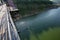 high angle view from the bridge The water in the reservoir has fishermen\\\'s boats. green water, mountains, forests surround