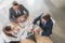 high angle view of business people using speakerphone during conversation