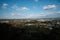 A high angle view of a city taken from the top of the mountain, overlooking the scenery and the bright blue sky