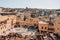 High-angle view of the cityscape and traditional tannery vats on a sunny day in Fes