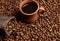 High angle view of a clay coffee cup with freshly brewed coffee drink with steam on the background of a bag with grains and