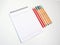 High angle view of colorful fineliner, pencil and notebook with white background