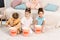 high angle view of cute multiethnic kids sitting on carpet and eating popcorn