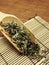 High angle view of dry mugwort on wooden spoon. Chinese herbal medicine.