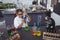 High angle view of elementary student examining blue chemical in flask at laboratory