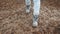 High angle view of female legs walking along incredible red and black pebble stone on Baltic sea beach slow motion.