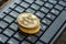 High angle view of four golden bitcoins on a keyboard