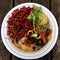 High angle view of fresh organic rubbish with red currants in a small white bowl for recycling