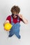 High angle view of funny young man, farmer with big lemons standing isolated over gray studio background. Concept of