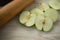 High angle view of granny smith apple slices by rolling pin