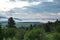 High angle view of a hill covered in trees, the Baie-Saint-Paul valley and the St. Lawrence River