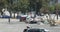 High angle view of a homeless person wandering through an encampment in a parking lot alongside the Hollywood freeway