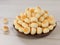 High angle view of little ball cookies on wooden plate isolated on wooden background.