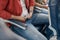 High angle view of male passenger adjusting and tightening a seatbelt on an airplane as he pulls on the belt with his