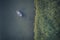 High angle view of male person rowing a boat on a lake