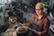 High angle view of mid adult industrial woman working indoors in metal workshop.