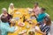 High angle view of multiracial senior friends enjoying food at table during backyard party