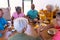 High angle view of multiracial senior friends having breakfast on dining table in retirement home