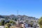 High angle view of a neighborhood with dense residential buildings near the cell tower on a mountain