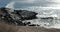 High angle view of ocean waves breaking on a rocky shoreline