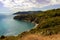 High angle view over Acquarilli Beach, a dark sand beach for nudist situated in the gulf of stella, Elba island, Italy