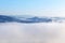 High angle view over tropical mountains with white fog in early morning