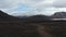High angle view panorama of 4x4 vehicle driving offroad stony terrain exploring wilderness of icelandic highlands. Top