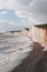 High angle view of pebble beach by Seven Sisters chalk cliffs, East Sussex, UK