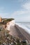 High angle view of pebble beach by Seven Sisters chalk cliffs in East Sussex, UK. Selective focus on the background