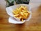 High Angle View of Pile of French Fries in Small Bucket  on Wooden Table