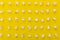 High angle view of popcorn in multiple rows on yellow background